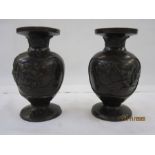 Pair of Japanese Meiji period Yoshida made bronze vases, ovoid bodies embossed in high relief with