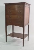 Early 20th century mahogany and satinwood banded four-drawer music cabinet with united undertier, on