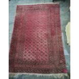 Red ground rug with repeating pattern to the central field, multi-stepped border, 296cm x 195cm