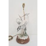 Resin and stained wood table lamp in the form of two herons, 55cm high approx