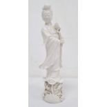 Modern Chinese blanc-de-chine Quan Yin holding a lotus flower and on base with further applied lotus