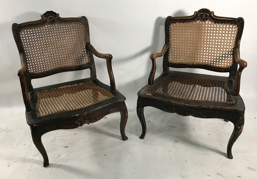 Two similar of possibly 18th century cane seated and backed low armchairs on cabriole legs (2) ***
