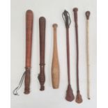 Victorian truncheon, no.3069, another vintage truncheon, a small wooden club and three riding crops