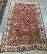 Red ground rug, possibly Persian, and possibly circa 1860, with allover hooked arabesques and