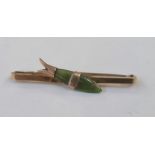 Gold coloured bar brooch set with a jade fish