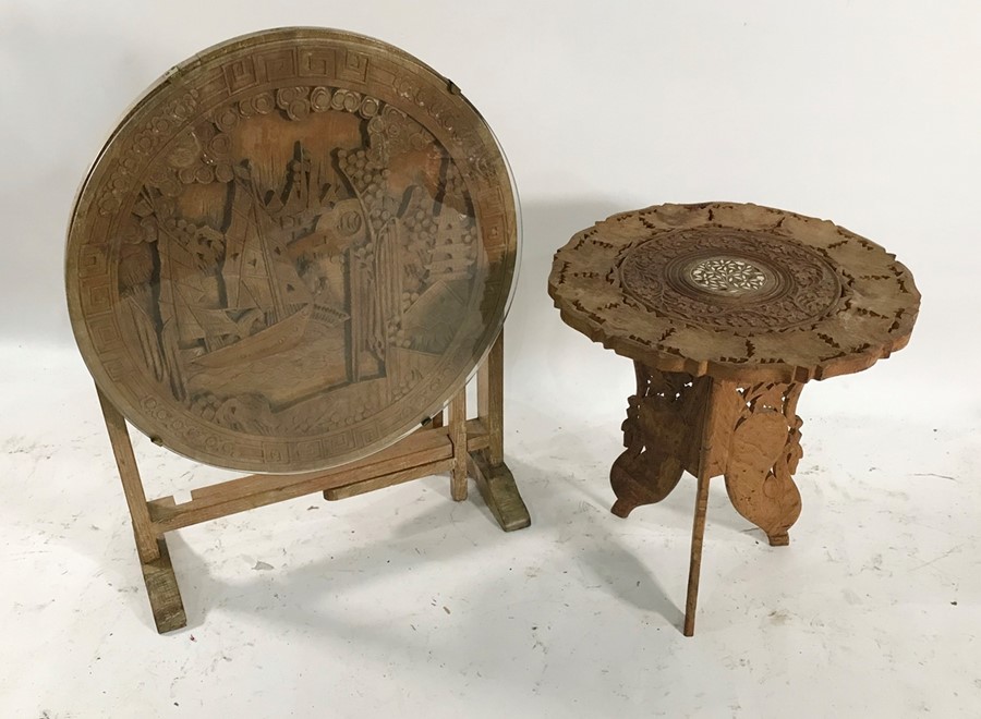 Modern Eastern circular table with carved top featuring figures in boat in landscape and one further