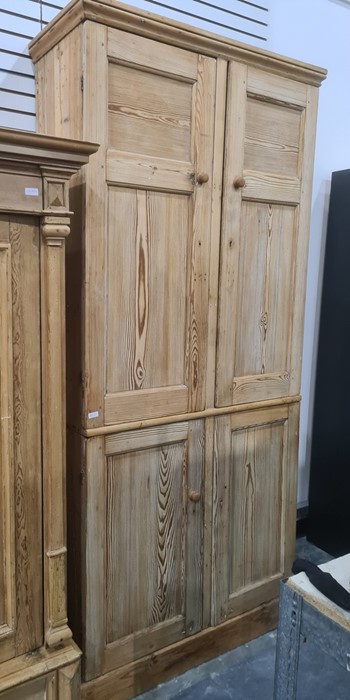 19th century pine cupboard with moulded cornice above two pairs of panelled doors, on plinth base,