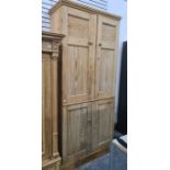 19th century pine cupboard with moulded cornice above two pairs of panelled doors, on plinth base,