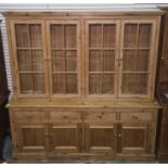 20th century pine dresser, the top with four glazed doors, the base of drawers and cupboard doors,