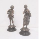 Pair bronze-effect spelter figures of boy writing and girl reading (2)