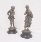 Pair bronze-effect spelter figures of boy writing and girl reading (2)