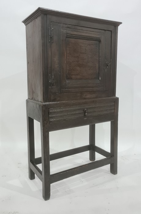 18th century oak livery cupboard, the rectangular top above cupboard door with pierced flowerhead