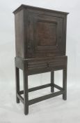 18th century oak livery cupboard, the rectangular top above cupboard door with pierced flowerhead