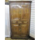 18th century oak standing corner cupboard with cavetto cornice, upper section enclosed by pair