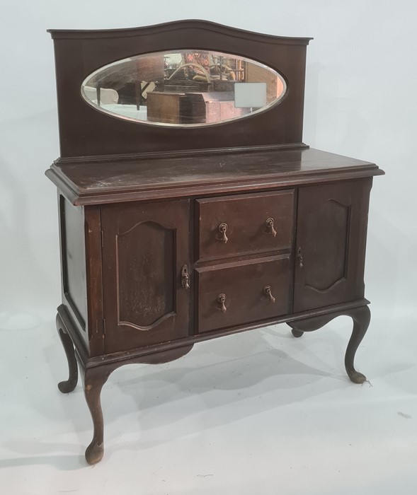 20th century sideboard with oval mirrored back above two central drawers and two cupboard doors,