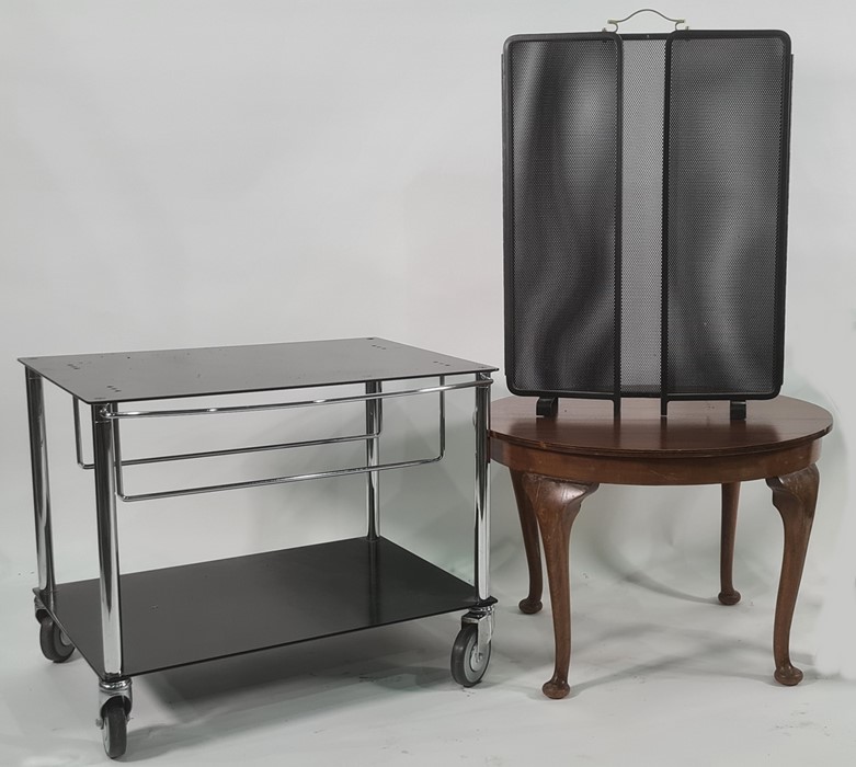 Modern two-tier low hostess trolley / tv stand on castors in black and chrome, on four castors, a