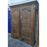 Possibly 19th century oak armoire with cavetto moulded cornice above two doors, to block feet, 165.