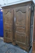 Possibly 19th century oak armoire with cavetto moulded cornice above two doors, to block feet, 165.