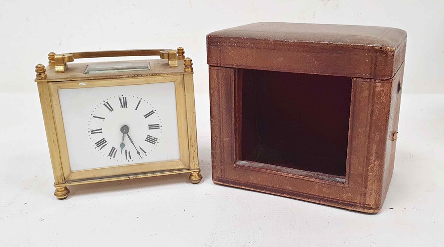 Brass and glass carriage clock of squat form, with Roman numerals to the dial, in carry case