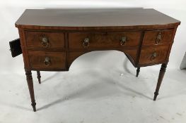 19th century mahogany sideboard the bowed front with five drawers, turned supports, peg feet, and