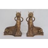 Empire style  gilt bronze chenets each in the form of sphinx with ring in mouth and on sweeping