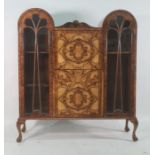 Early 20th century walnut cabinet, the double domed top with central shelf above fall, drawer and