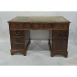 20th century pedestal desk with green leatherette inset top, nine drawers, on bracket feet, top