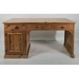 20th century pine desk with three assorted drawers and single cupboard door, on plinth base, 151cm