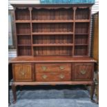 20th century dresser of assorted open shelves above base of two drawers and two cupboard doors,