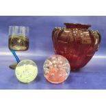 Red glass vase, shouldered with relief, trail decoration and panelled, two glass paperweights and