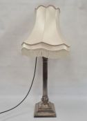 Large silver-plated corinthian column table lamp with ram's head detail, on square stepped base,