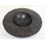 Dark wood carved sculptural bowl, circular with incised base and broad rim, 46cm wide