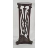 19th century mahogany aspidistra stand, the circular top above a base of Egyptian taste, to