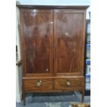 Early 20th century mahogany wardrobe, the cavetto cornice above two doors and two drawers, on square