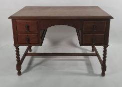 Early 20th century oak desk with four drawers, on barleytwist and block supports to stretchered