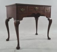 18th century oak lowboy of three drawers, the rectangular top with moulded edge, raised on