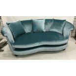 Pair of Wesley barrel two-seat sofas in turquoise velvet upholstery and footstool with optional