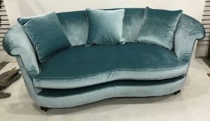 Pair of Wesley barrel two-seat sofas in turquoise velvet upholstery and footstool with optional