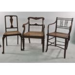 Five assorted chairs to include cane seated spindle back chair, rush seated chair, wheelback chair