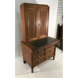 20th century oak desk / dressing cabinet, leather writing surface revealing inkwells, the upper