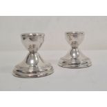 Pair of 20th century silver-mounted squat candlestick holders, reeded decoration, on circular bases,