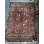 Eastern rug with 10 elephant foot guls to central field , 139 x 94 cm Condition ReportThere is