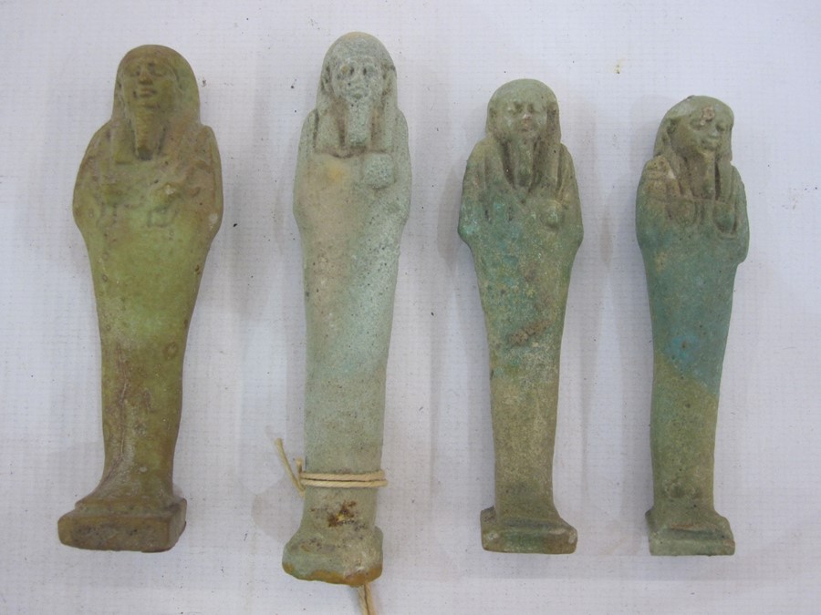 Four Egyptian blue glazed faience Ushabti in typical mummified form, one with swing label