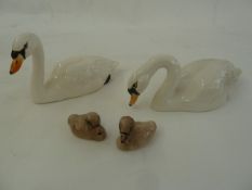 Beswick model swan family viz:- one swan with head raised, one drinking and two cygnets  Part of the