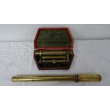 Brass theodolite telescope, 9cm long, in red morocco case and a brass cylindrical sight (2)