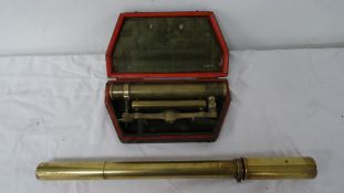 Brass theodolite telescope, 9cm long, in red morocco case and a brass cylindrical sight (2)
