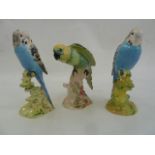 Two Beswick model budgies, 1216 and 1217 in blue and a parrot 930 in yellow and green (3)  Part of