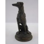 Bronzed figure of a seated greyhound, on circular base, marked F Souchal Paris to base, 17cm high