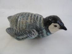 Beswick model penguin chick on his stomach, 2434  Part of the Wildfowl and Wetlands Trust Collection