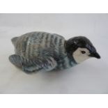 Beswick model penguin chick on his stomach, 2434  Part of the Wildfowl and Wetlands Trust Collection